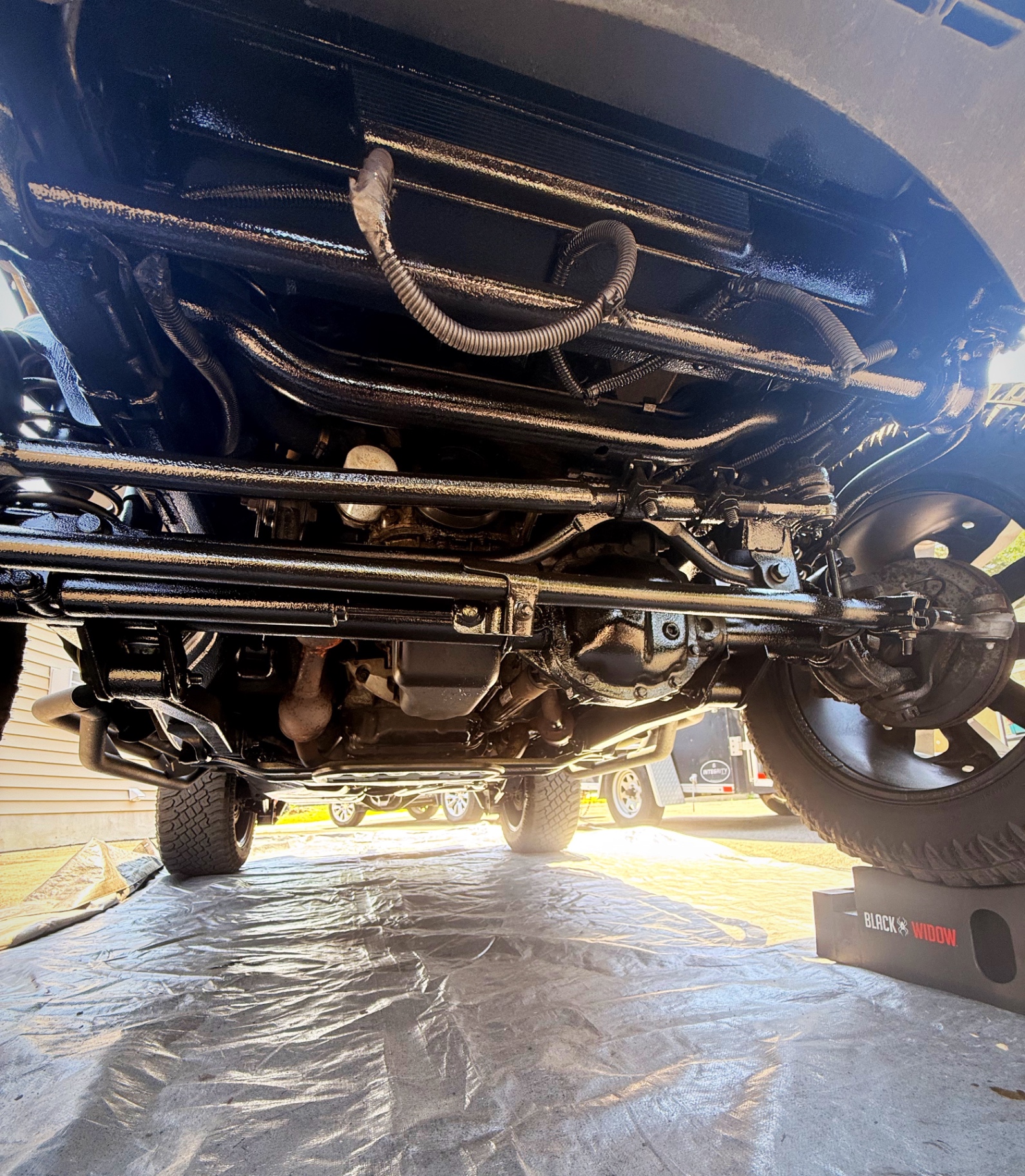Freshly undercoated front axle and frame